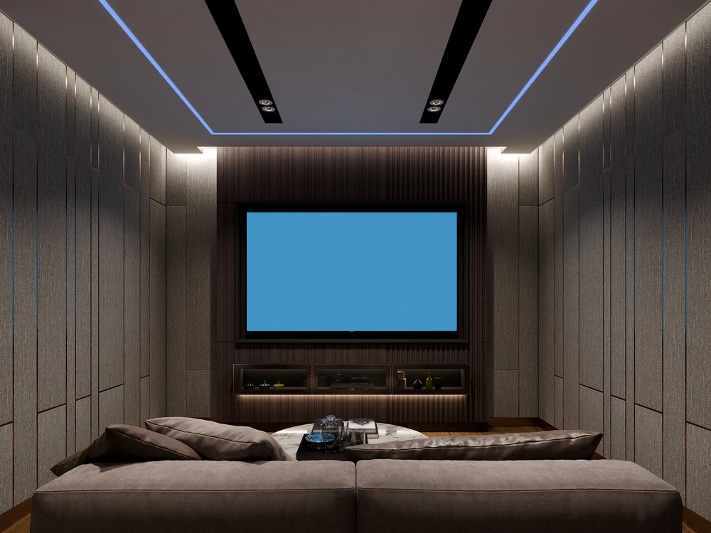 Modern media room with large TV and acoustic wall treatment panels