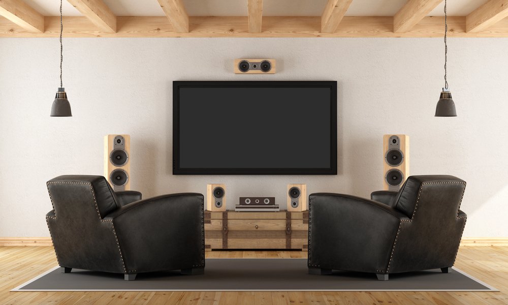 Rustic media room with large TV and floor-standing tower speakers