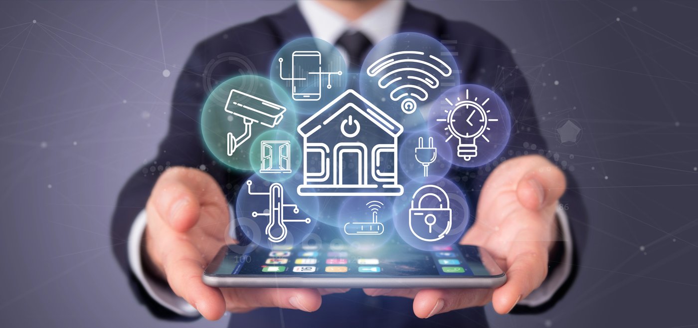 Businessman holding tablet with smart home holographic interface