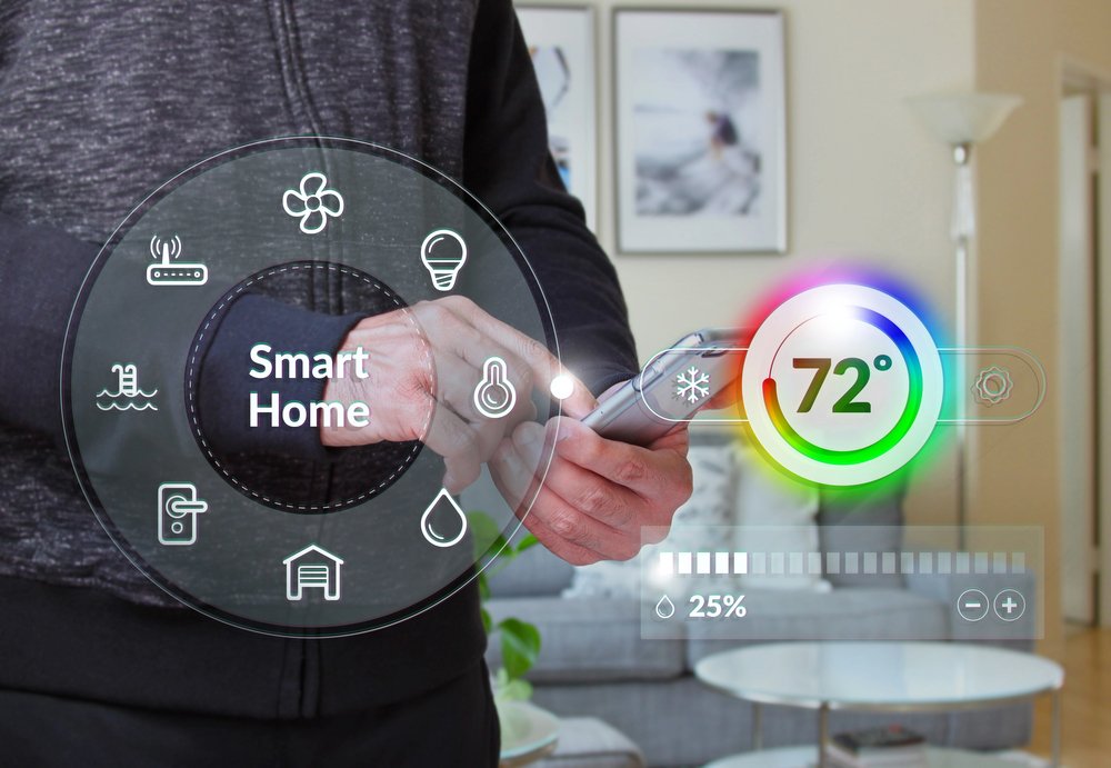 Homeowner using smartphone to control smart thermostat and climate settings